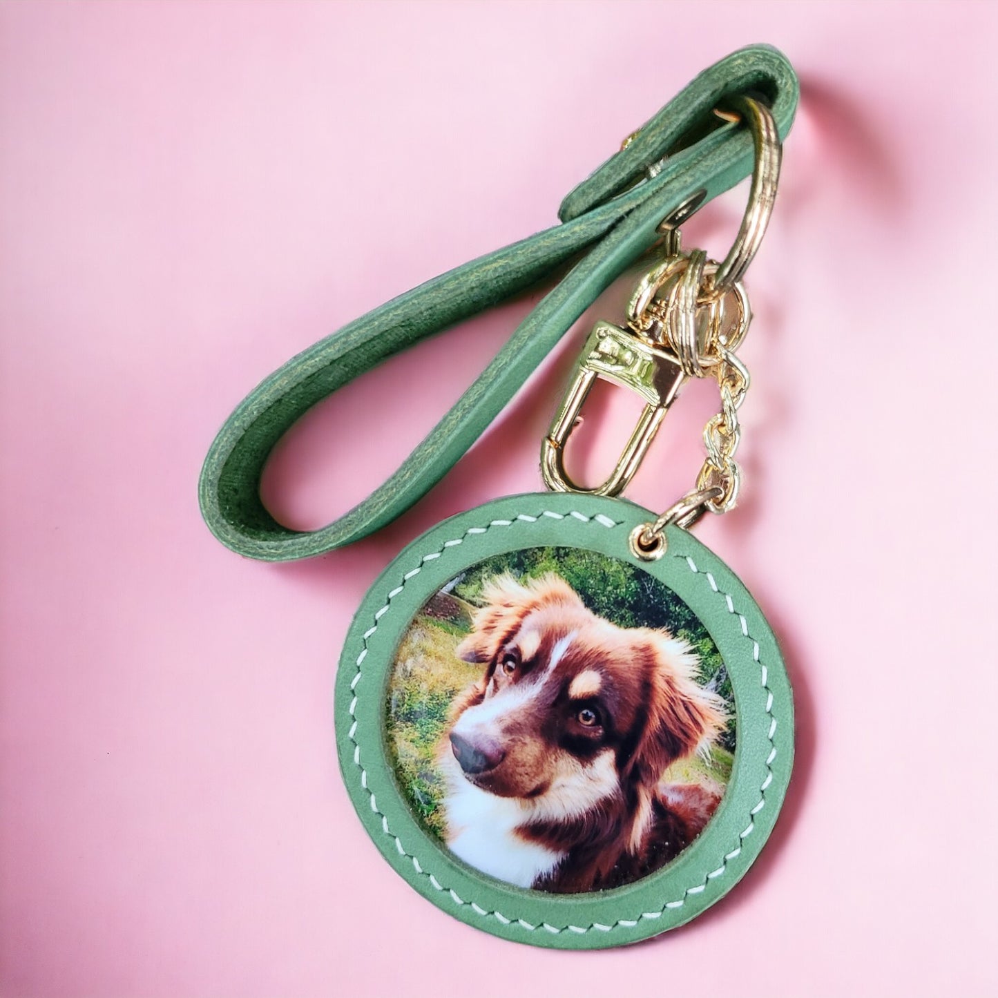 Customizable handcrafted vegan leather photo charm keychain featuring a picture of a brown and white dog on a pink background