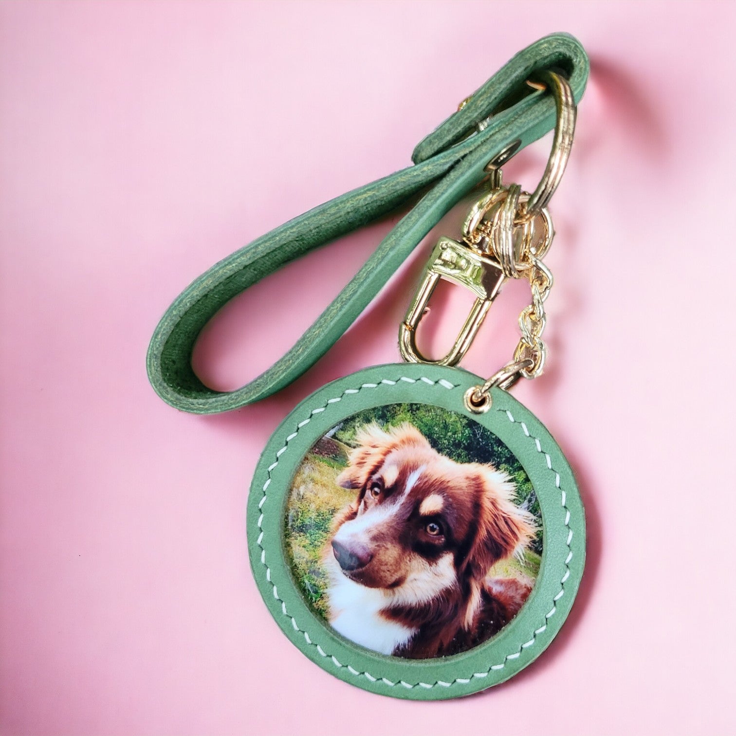 Customizable handcrafted vegan leather photo charm keychain featuring a picture of a brown and white dog on a pink background