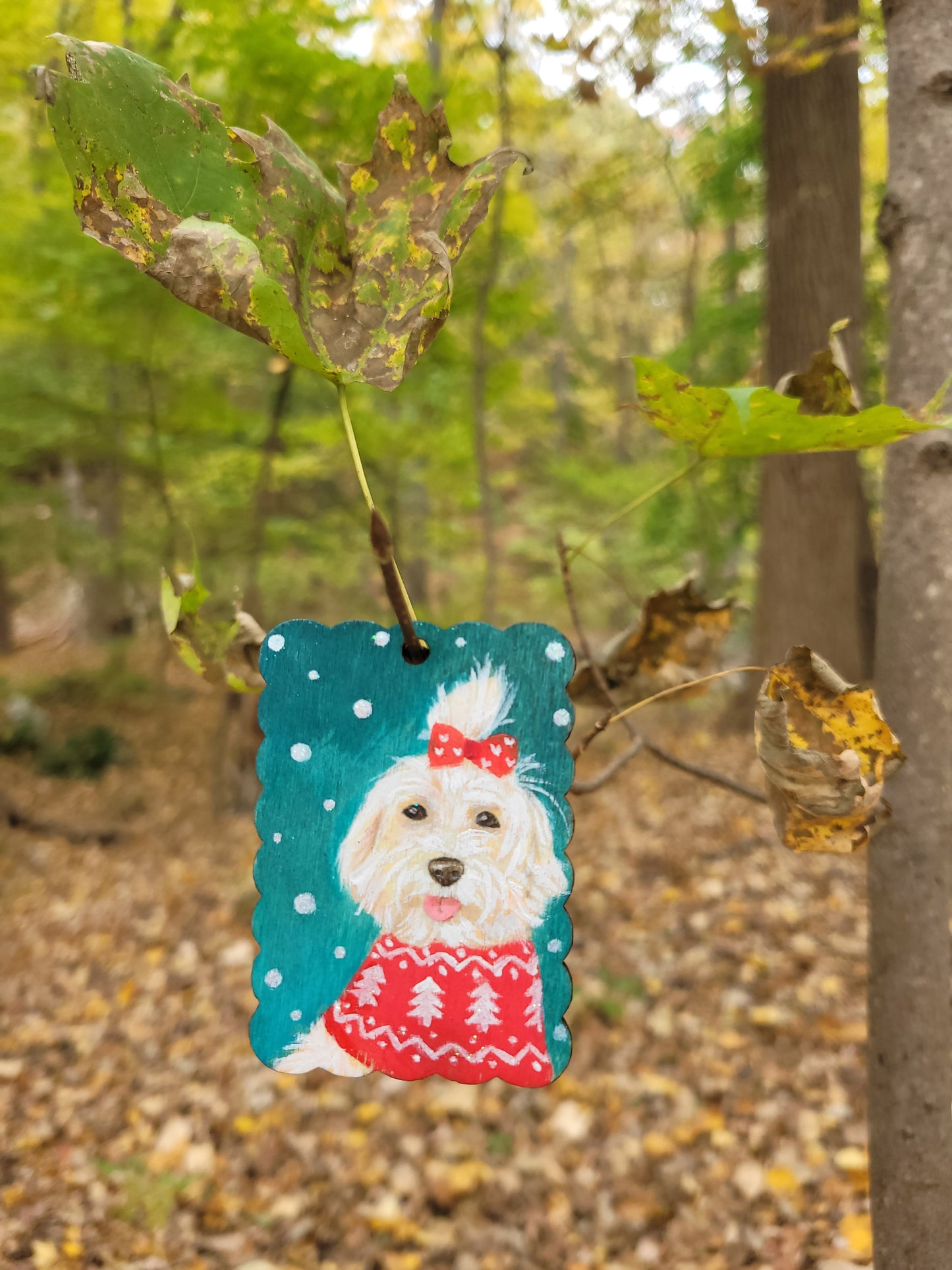 Hand-painted dog Christmas ornament wood tag, designed with a dog wearing a red holiday sweater.