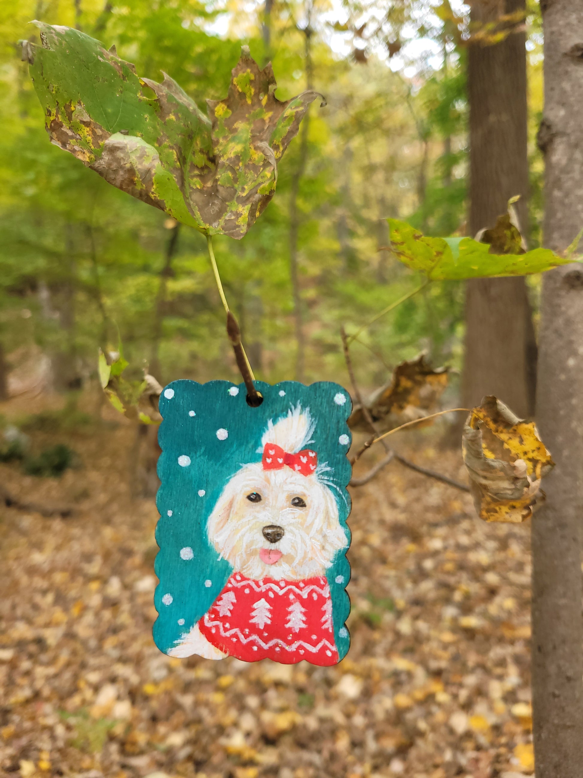 Hand-painted dog Christmas ornament wood tag, designed with a dog wearing a red holiday sweater.