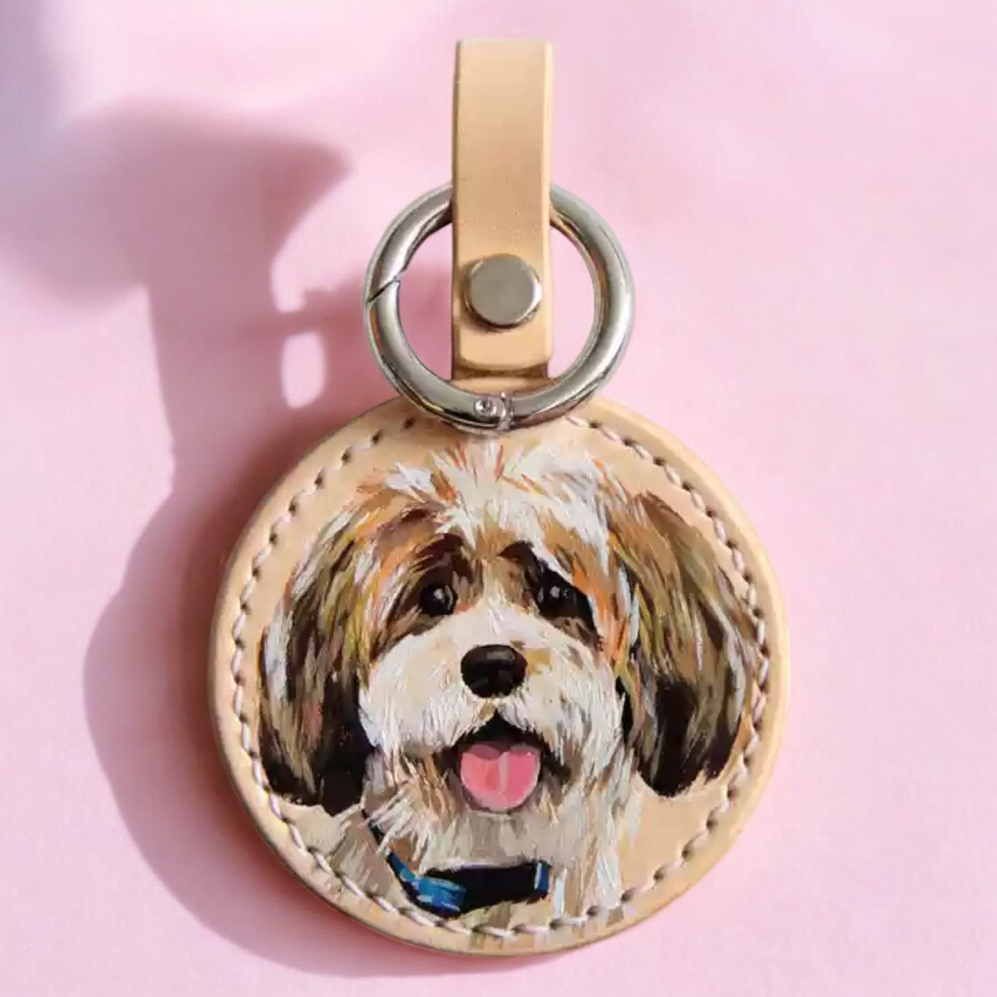 Hand-painted leather keychain featuring a custom portrait of a Shih Tzu dog, capturing lifelike details and vibrant colors.
