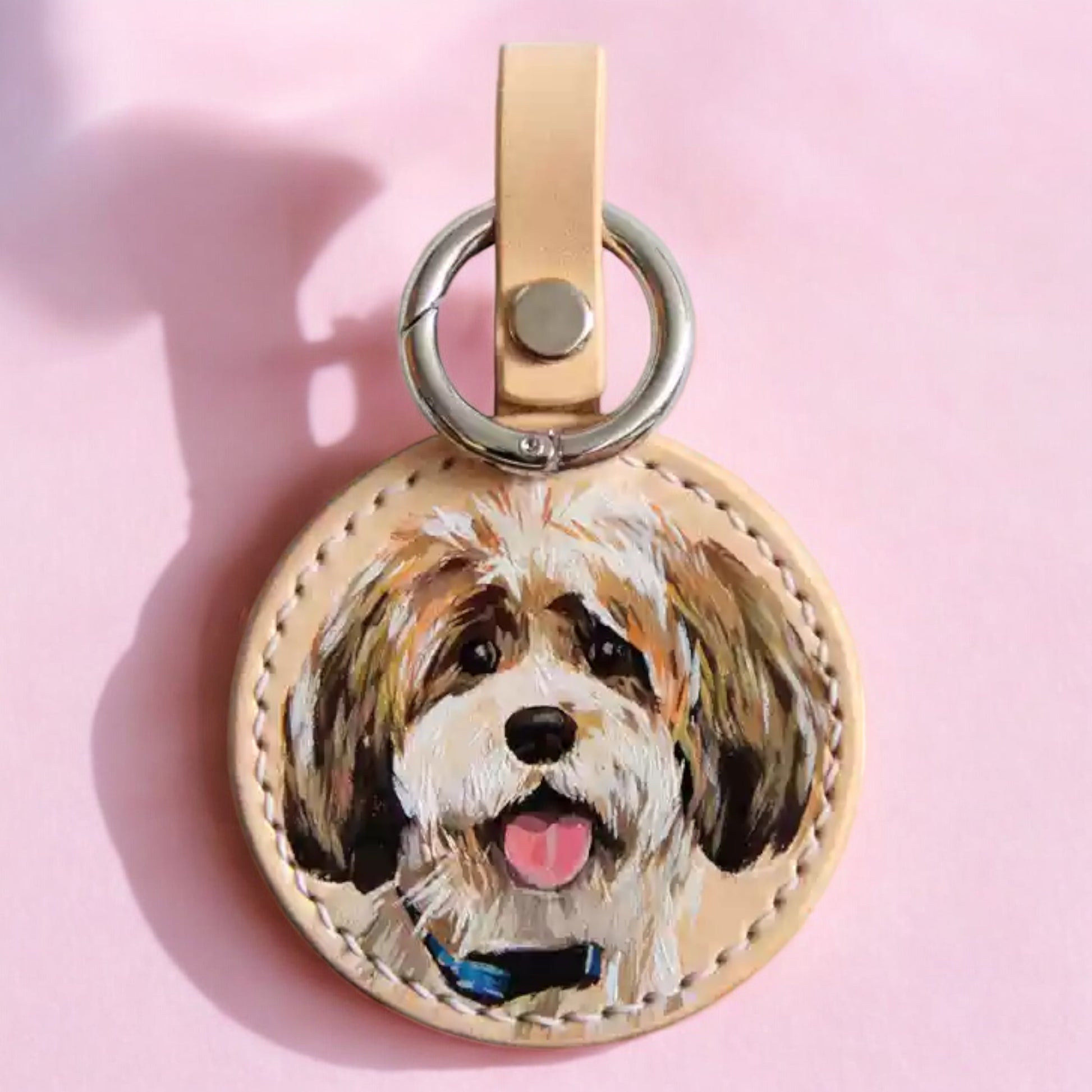 Hand-painted leather keychain featuring a custom portrait of a Shih Tzu dog, capturing lifelike details and vibrant colors.