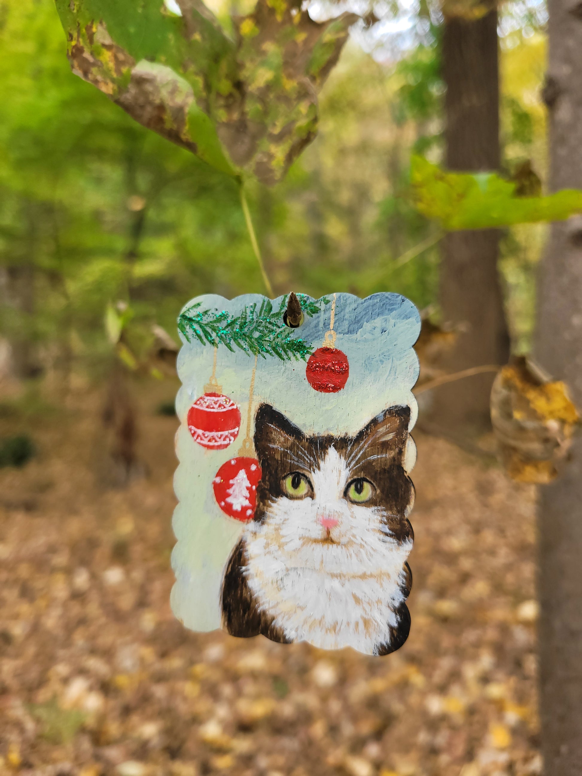 Pet memorial ornament for Christmas, featuring a custom hand-painted cat on a wooden tag.
