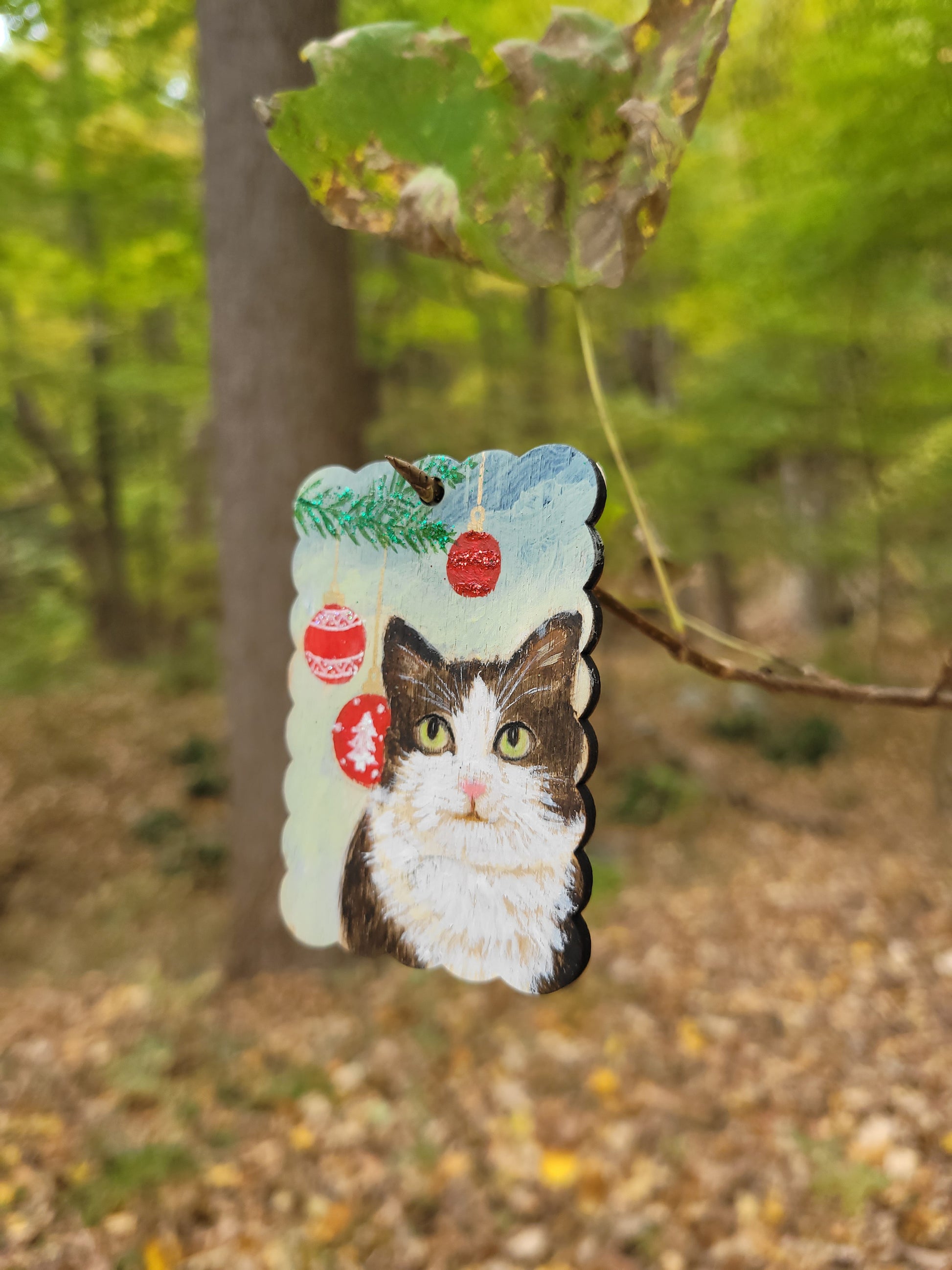 Handmade cat portrait Christmas ornament for tree decor, painted on a wooden tag.