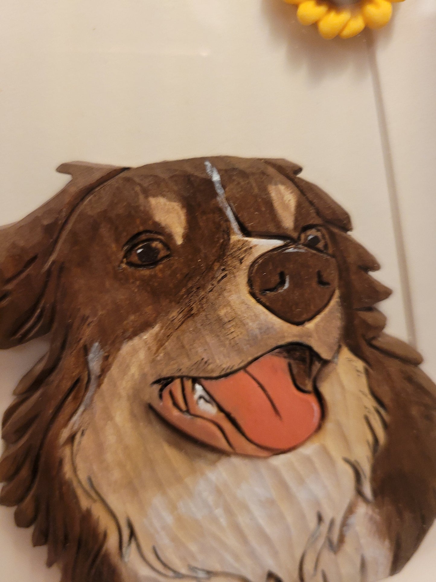 Close-up of details for personalized handcrafted wood carving pet portrait.