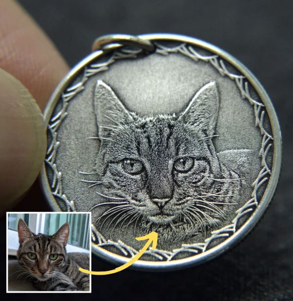 Close-up of handcrafted sterling silver necklace featuring a detailed cat portrait