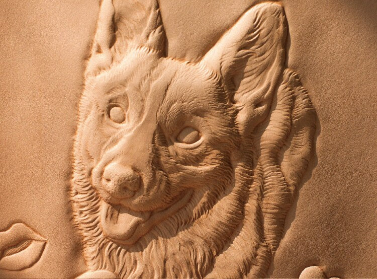 Side view showing the depth and details of the hand-carved leather frame featuring a dog