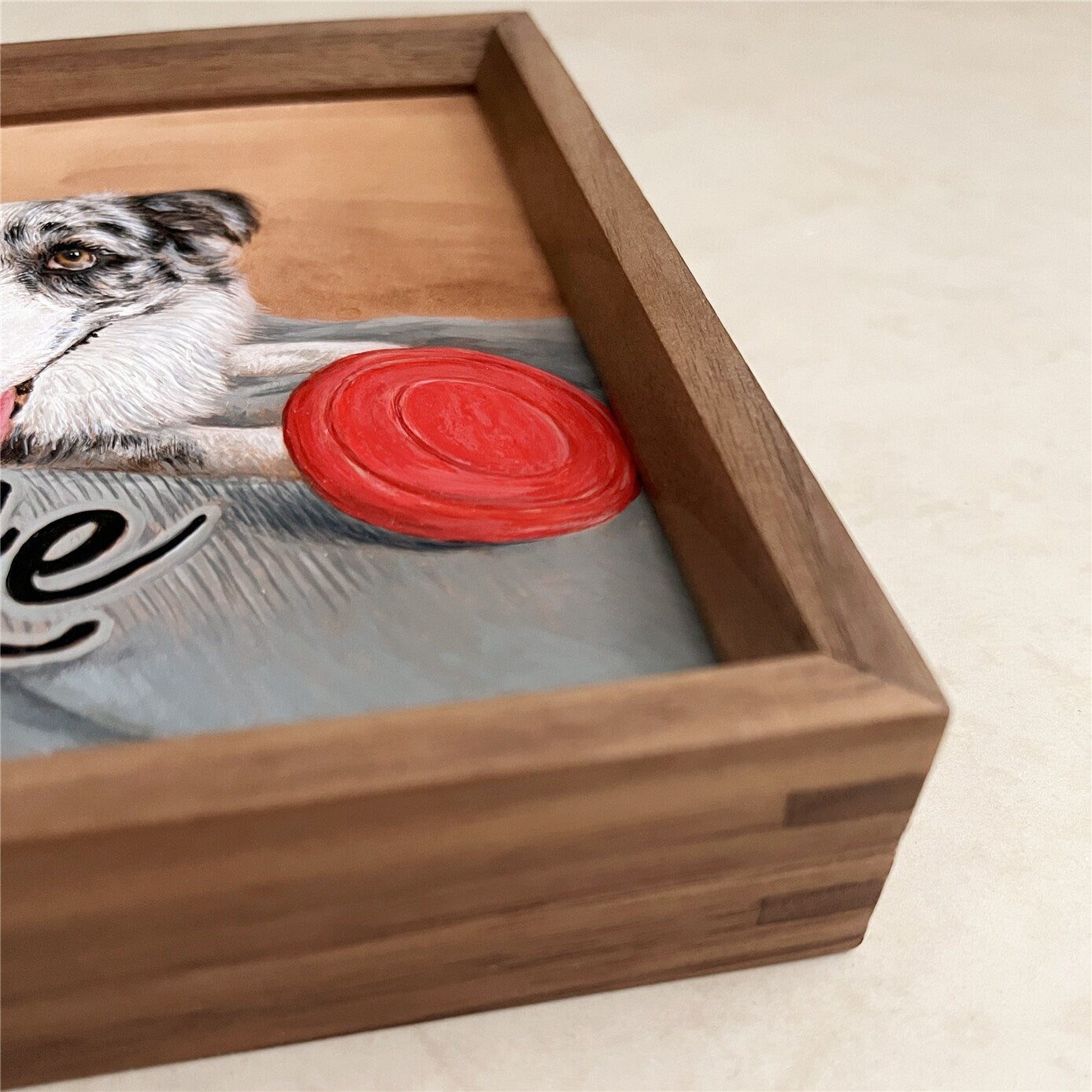 Close-up of the dogās face in the custom pet portrait hand-carved leather frame