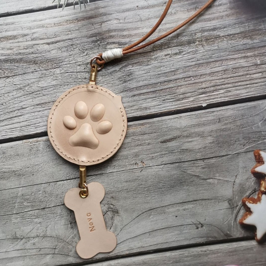 Back view of customizable handcrafted pet portrait car mirror charm with 3D paw print design and name tag