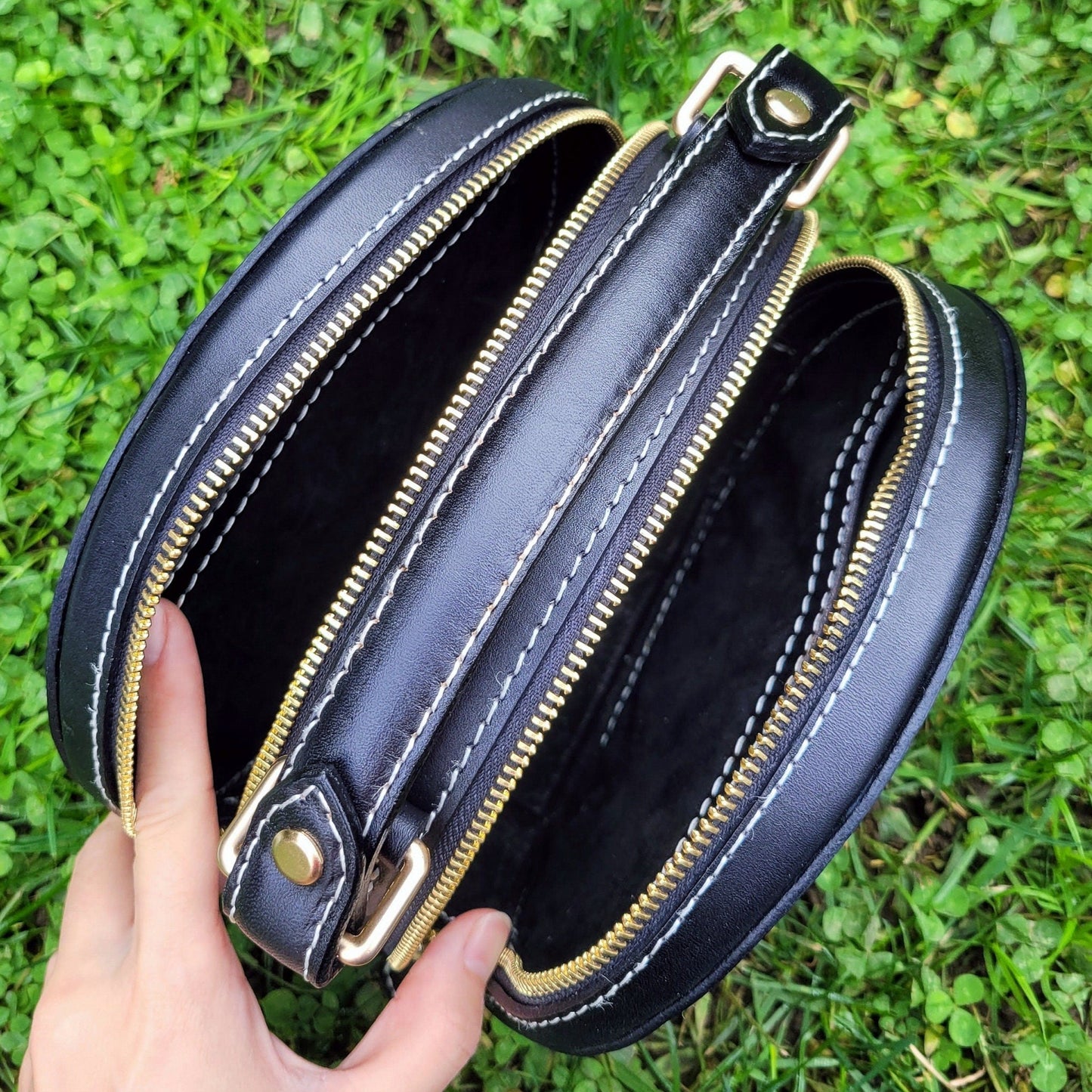 Close-up of the interior of a custom-painted leather handbag showing spacious compartments.