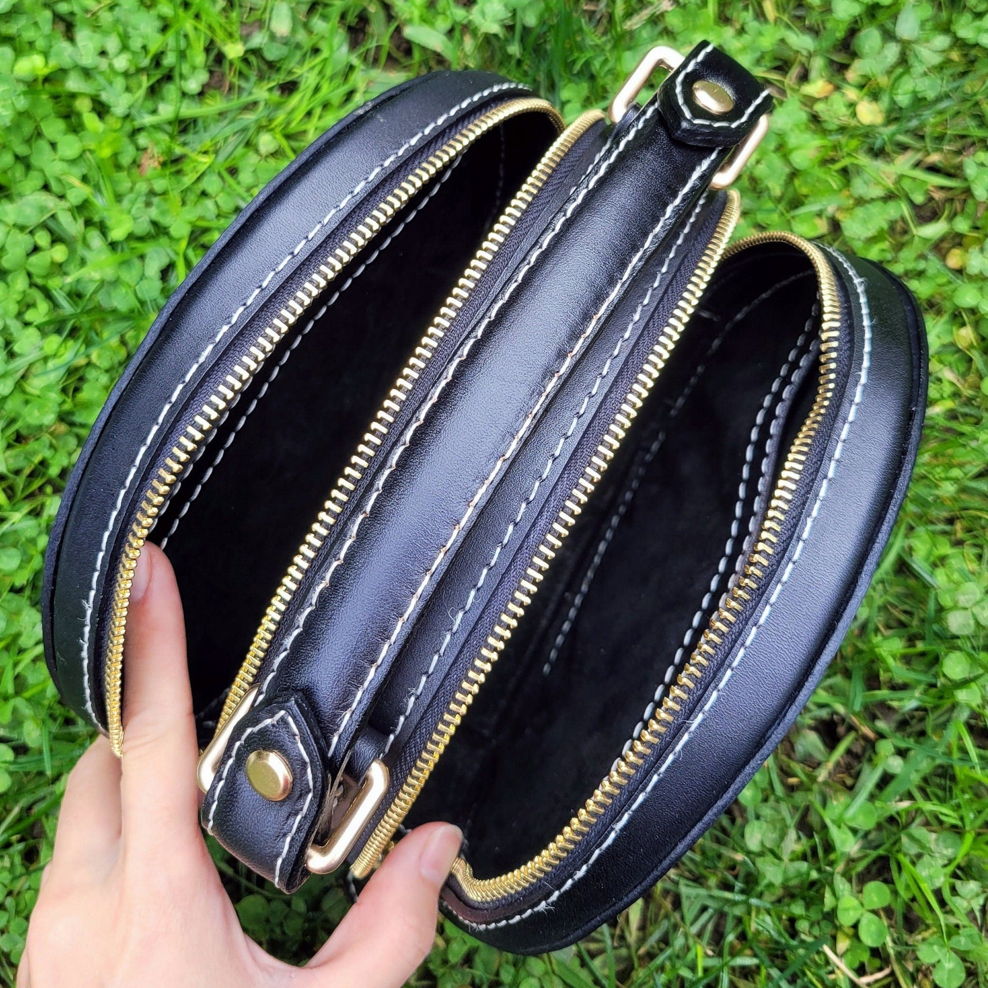 Close-up of the interior of a custom-painted leather handbag showing spacious compartments.