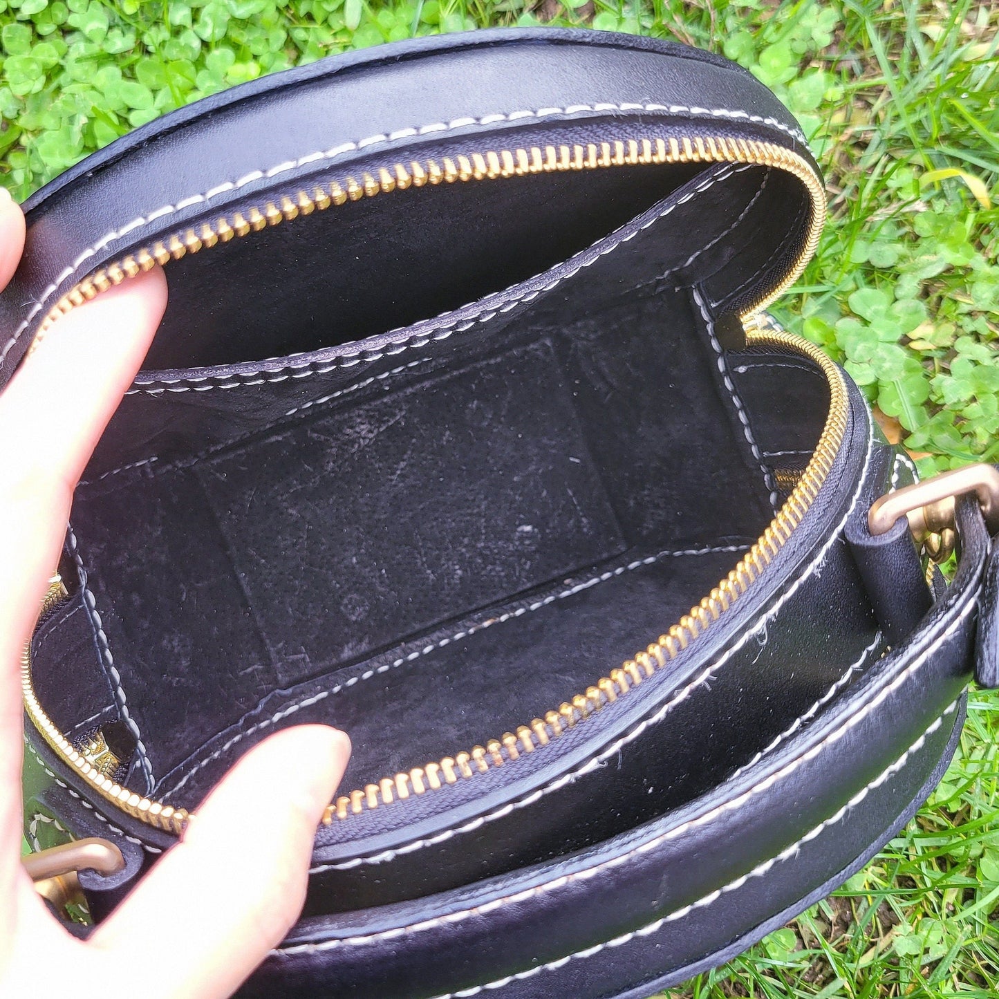 Image of a woman holding a custom dog portrait leather handbag, showcasing its size