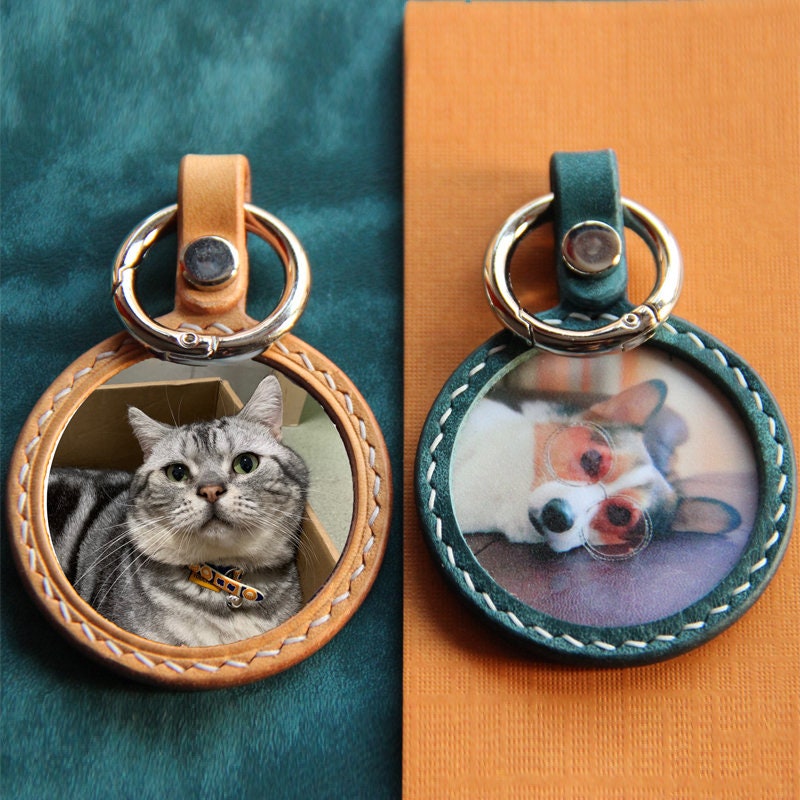 Customizable handcrafted keychain of cat and dog pet portraits in orange and green variation