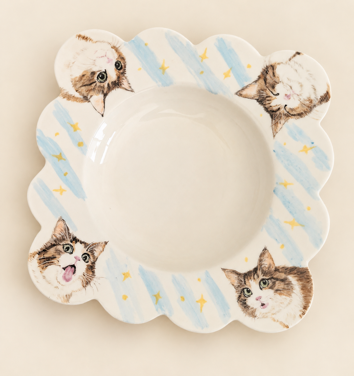 Hand-painted pet portrait plate with blue stripes on a plain backdrop