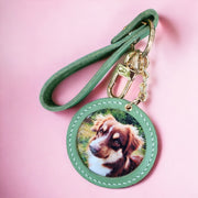 Customizable handcrafted vegan leather photo charm keychain featuring a picture of a brown and white dog on a pink background