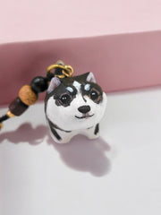Hand-painted custom pet portrait keychain featuring a cute dog with beads on a black cord, front view.