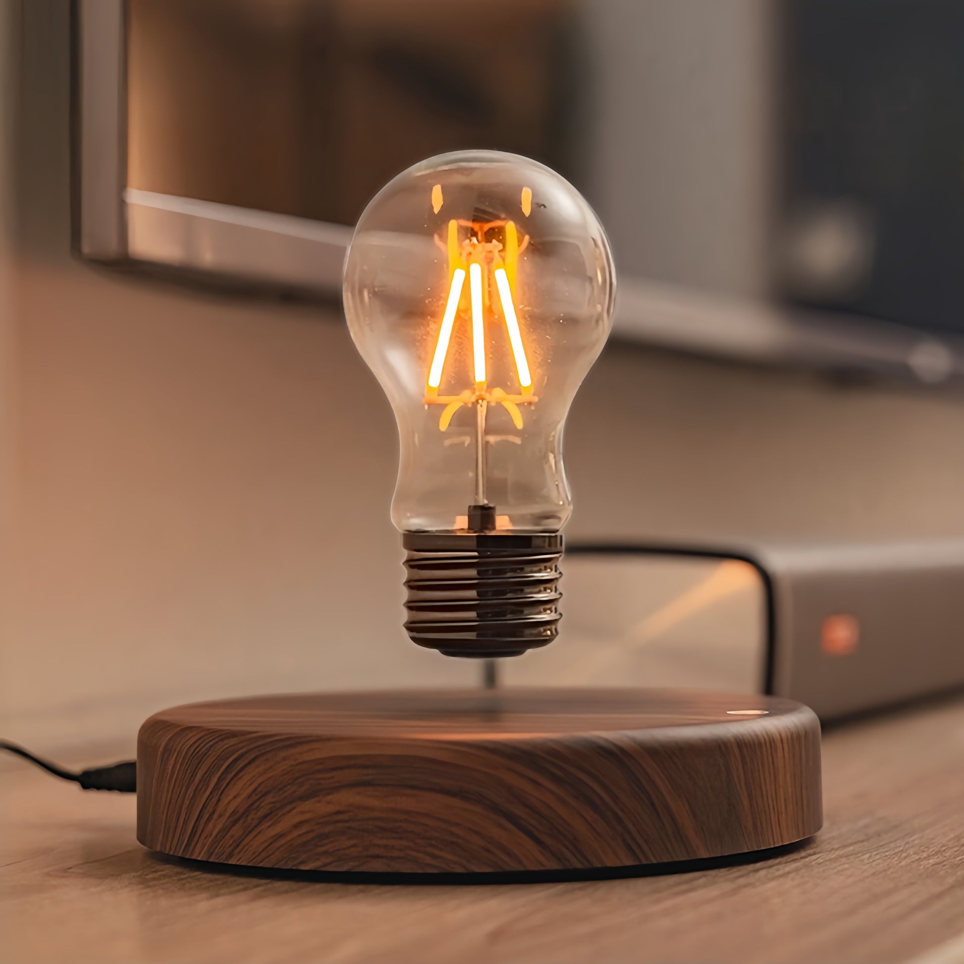 Floating light bulb with wooden base in a cozy room setting