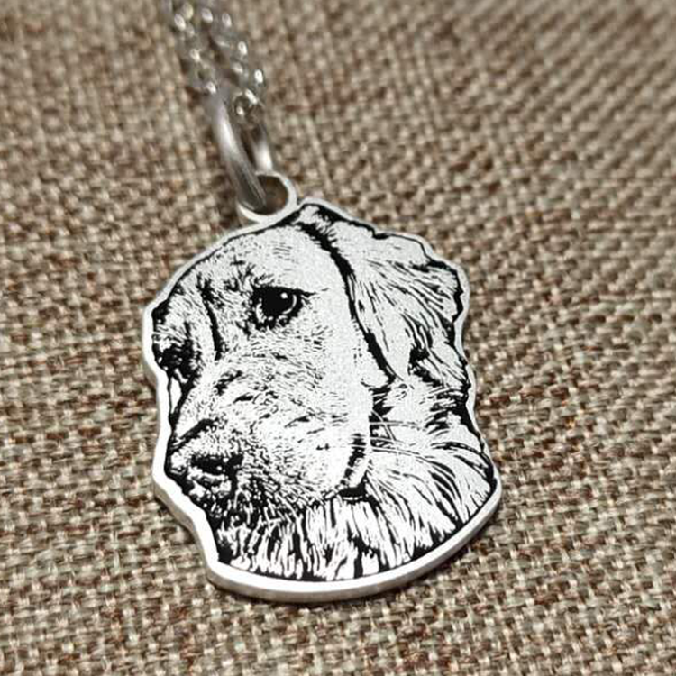 Sterling silver custom engraved dog portrait pendant, capturing the detailed likeness of a beloved pet.