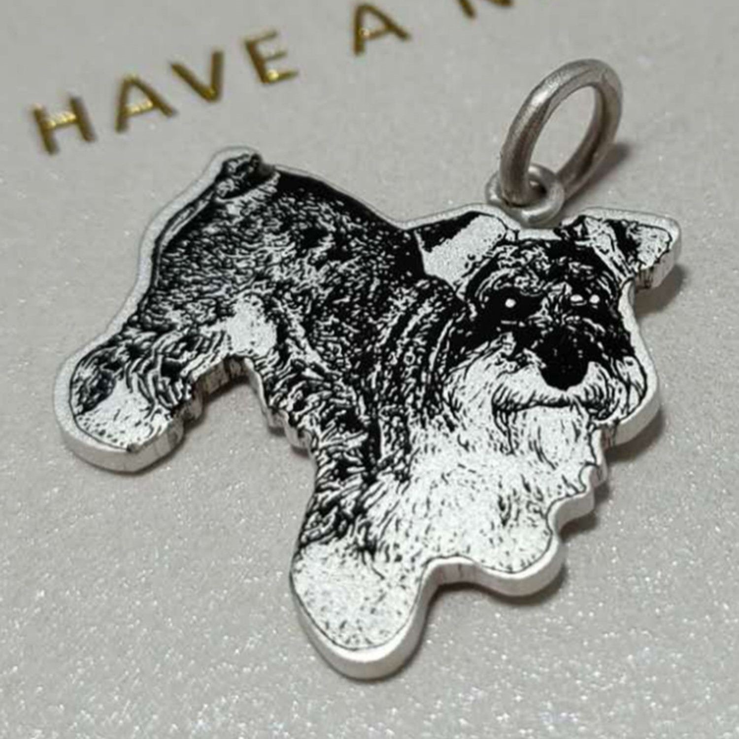 Sterling silver custom engraved schnauzer dog portrait pendant, beautifully detailed and personalized for pet owners.