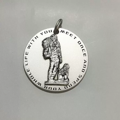 Custom engraved pendant featuring a person with a dog, shown against a plain background.