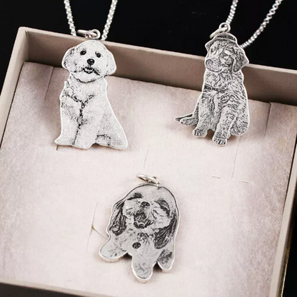 Custom engraved pet portrait necklaces with three different dog designs, showcasing intricate and personalized craftsmanship.