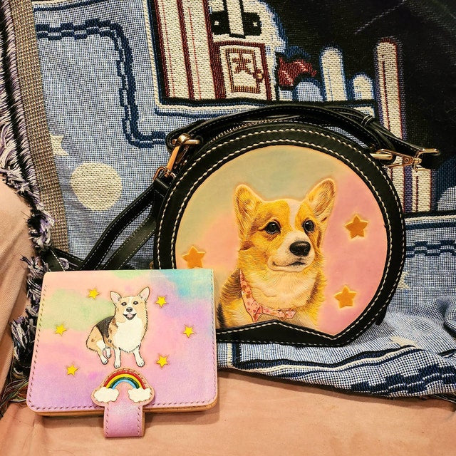 Custom pet portraits of a Corgi dog on a black leather bag and a colorful wallet with stars and rainbow designs