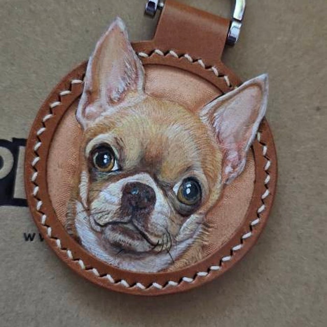 Custom pet portrait of a Chihuahua dog on a round leather keychain, personalized artwork with detailed stitching