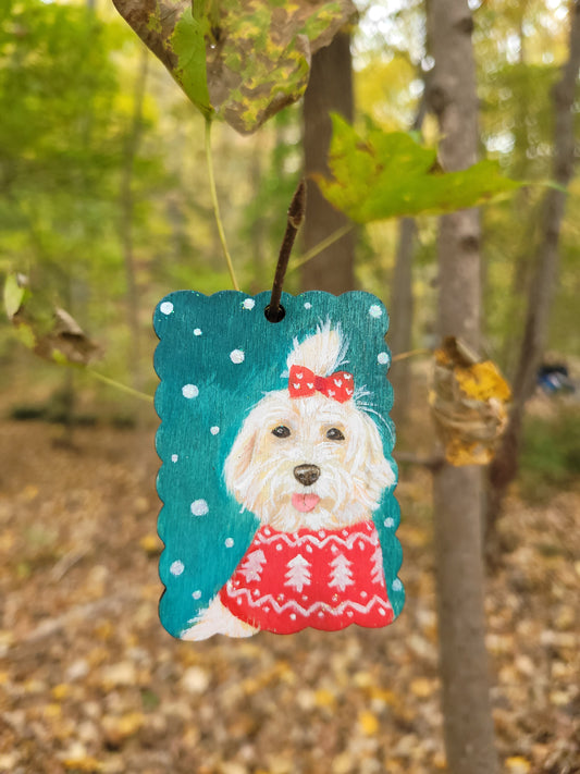 Custom holiday dog ornament wood tag, hand-painted with a white dog in a festive red sweater.