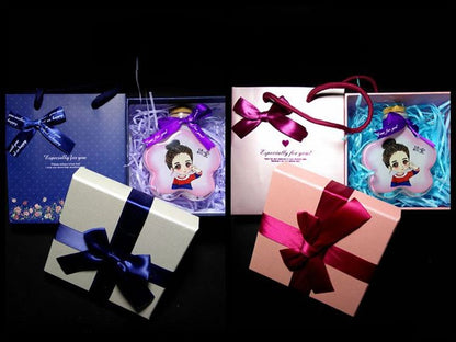 Two hand-painted sand bottles presented in elegant gift boxes with decorative ribbons, perfect for personalized gifts.