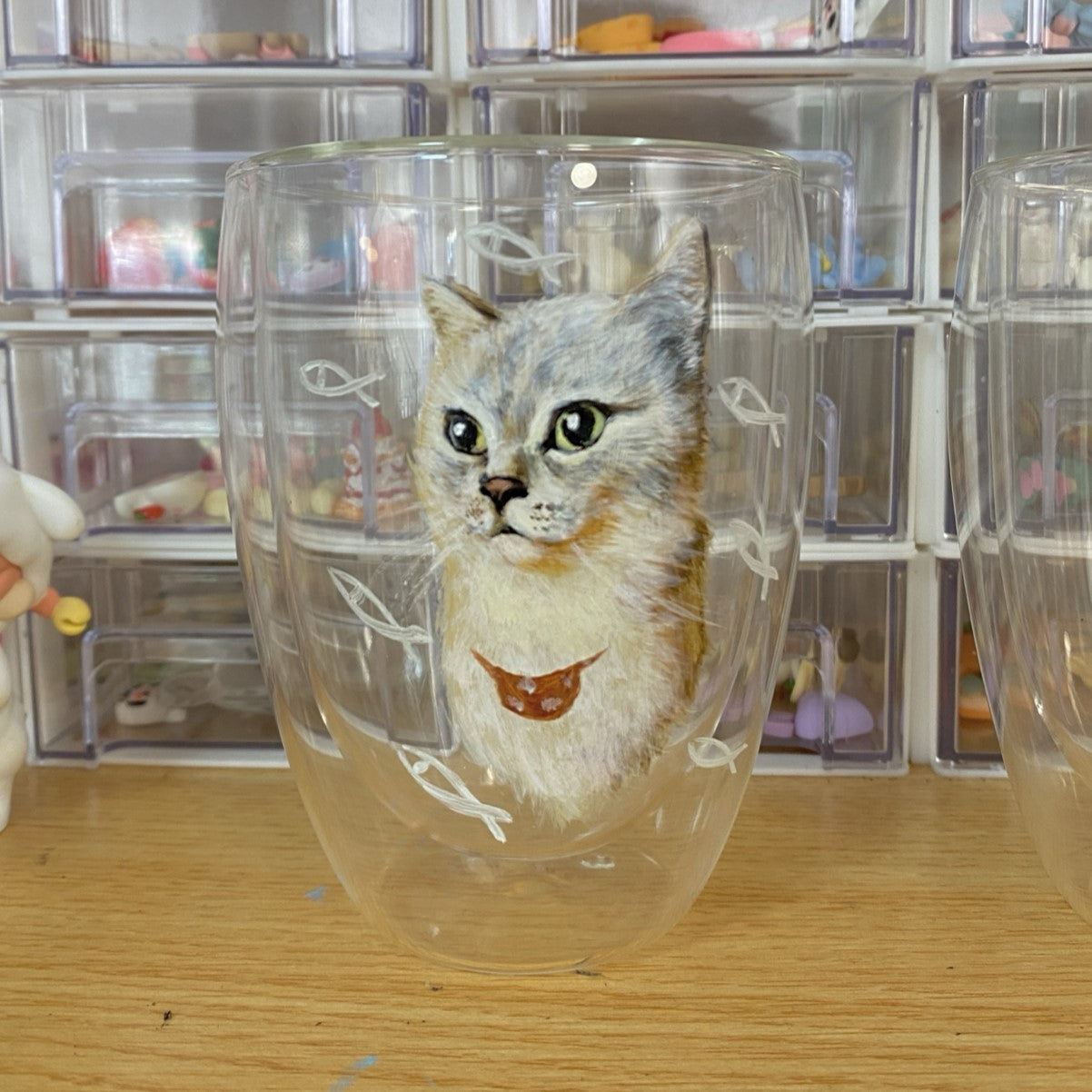 Double-layer glass insulation cup featuring a custom hand-painted portrait of a grey and white cat with fish pattern background.