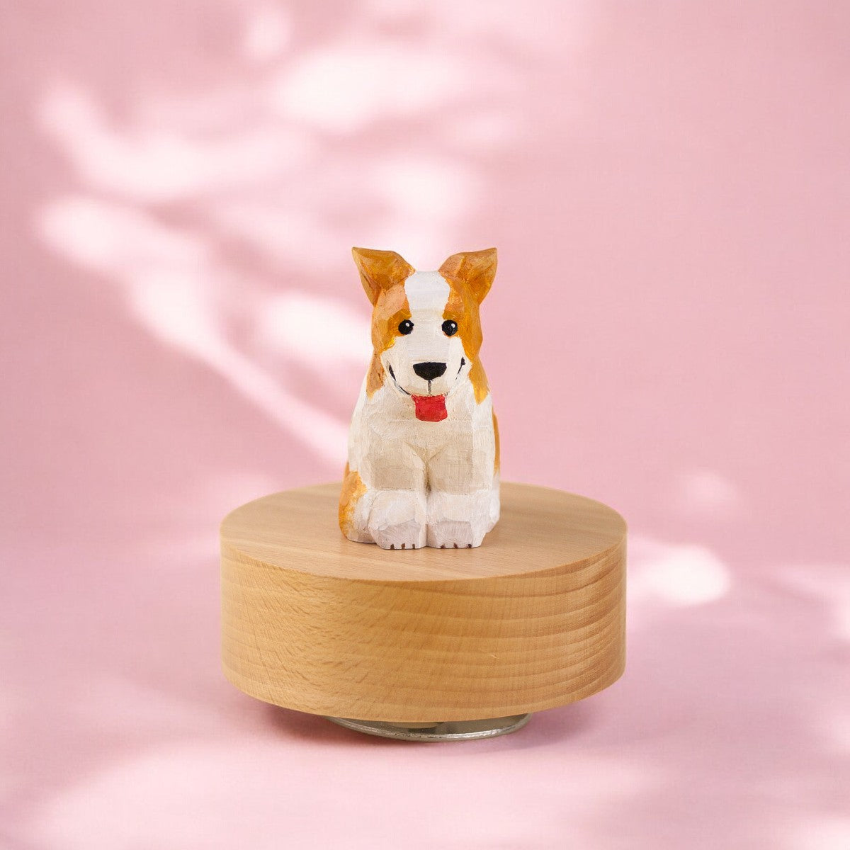  Hand-painted wooden dog figurine on a round wooden base with a pink background