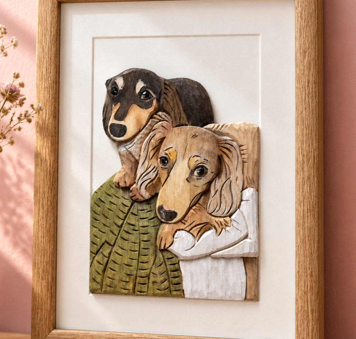 Hand-carved leather portrait of two dachshunds in an oak frame