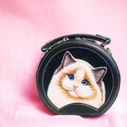 Black round leather handbag with a hand-painted cat portrait in a Japanese style.
