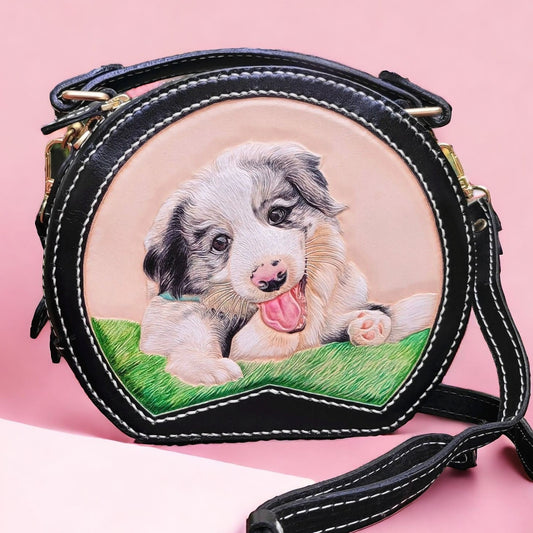 Round leather handbag with a hand-painted portrait of a playful dog on the front