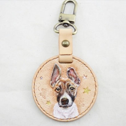 Custom hand-painted leather keychain with a portrait of a tan dog
