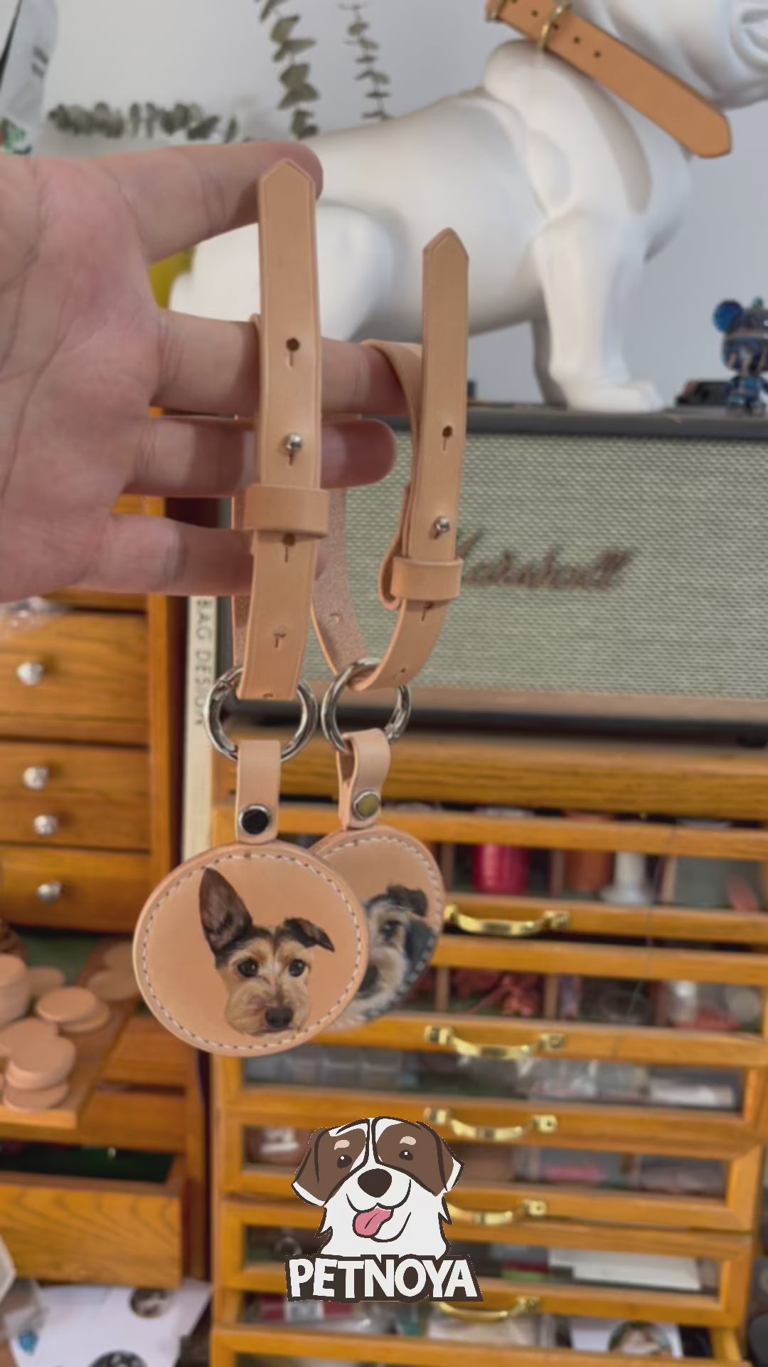 A video demonstrating a custom hand-painted leather luggage tag with a pet portrait, showing the craftsmanship and detail in the artwork.