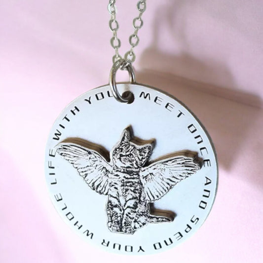 Sterling silver double layer 3D round pendant with a cat's face and wings, shown on a chain