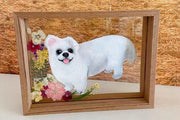 Custom pet portrait featuring a small dog with a flower crown, hand-painted on glass with a wooden frame.