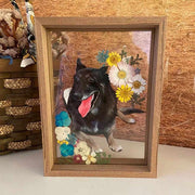 Custom hand-painted black dog portrait on glass with a wooden frame, adorned with colorful flowers.