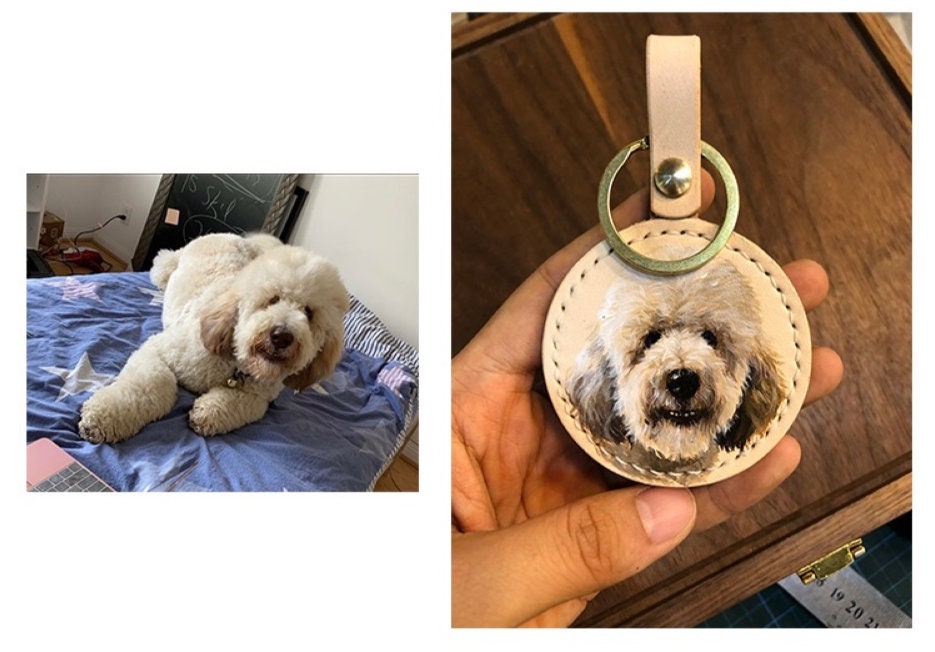 Two handpainted leather keychains with portraits of different dogs, shown side by side